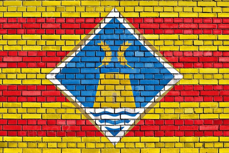 Flag of Formentera painted on brick wall