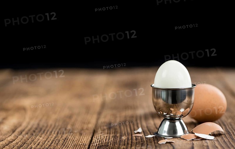 Wooden table with boiled Eggs (selective focus, close-up shot)