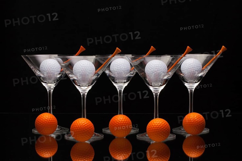 Five glasses of champagne with golf balls