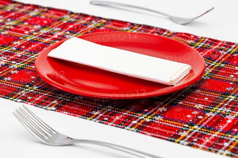 Red plate and Christmas decoration on the white wooden table.Top view. Flat Lay Image