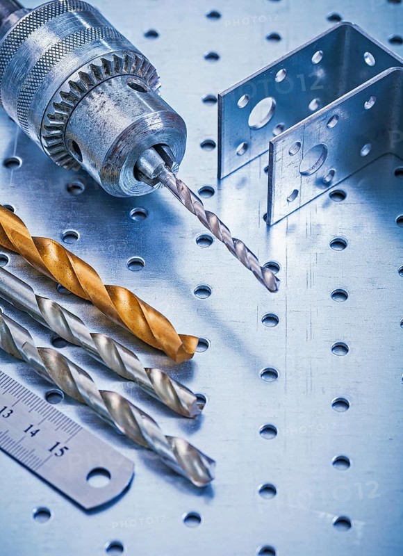 Perforated angle fasteners metal ruler drill and bits on metallic background construction concept