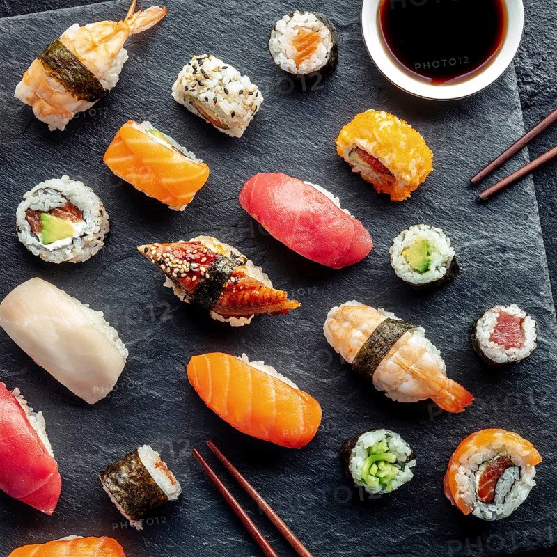 Sushi, overhead square shot with chopsticks and soy sauce. Rolls, maki, nigiri on a black background, Japanese food. Salmon, tuna, eel, shrimp and other seafood, Food photography, Food photography