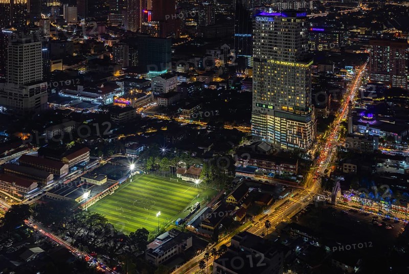 A picture of the EV Arena Kelab Sultan Sulaiman football field, and the Tamu Hotel and Suites Kuala Lumpur, at night