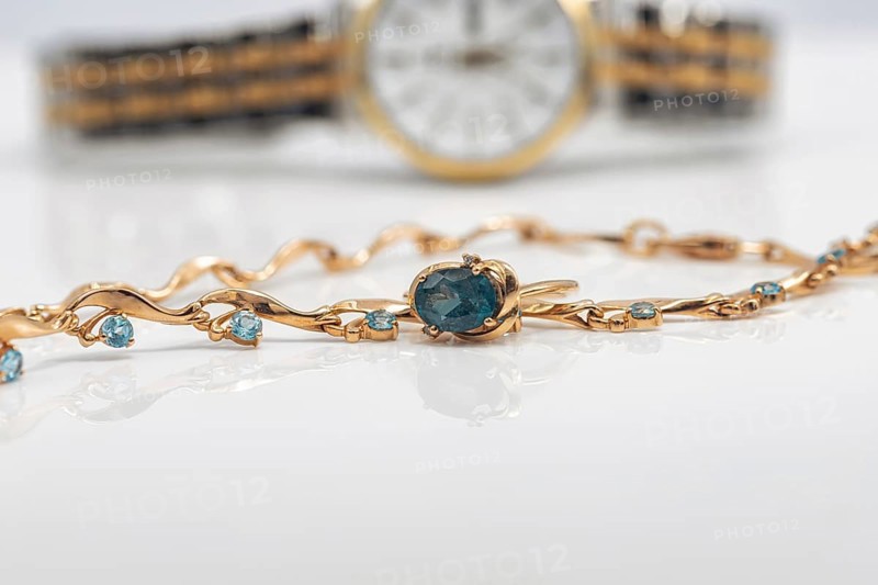 Accessories and jewelry for a fashionable girl : gold ring, necklace and original wristwatch