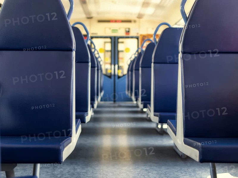 An empty train car with new blue leather seats