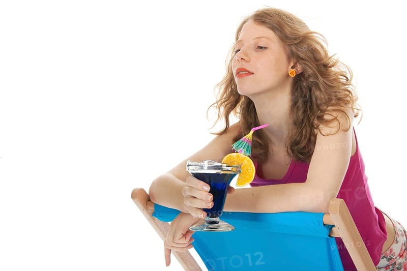 Younb blond woman with luxury cocktail at the beach