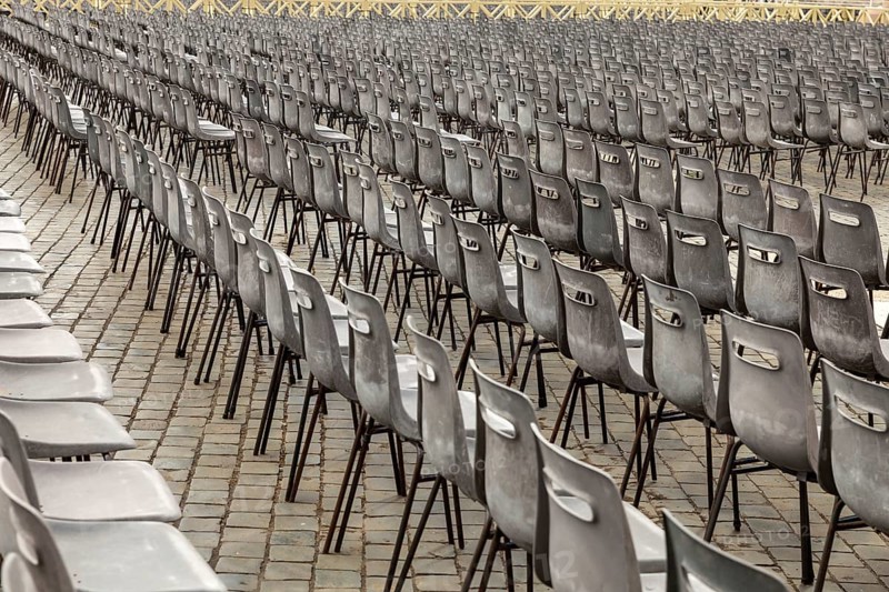 Aligned chairs prepared for an outdoor event