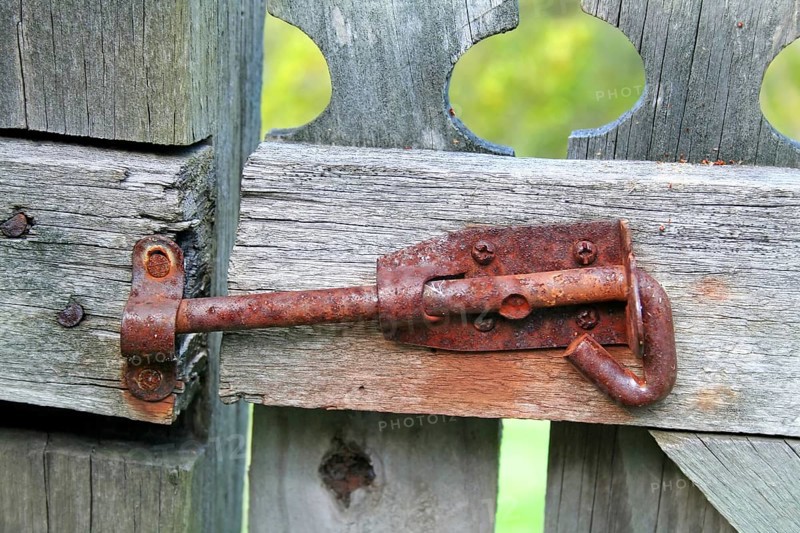 Rusty old latch on an old wooden garden gate