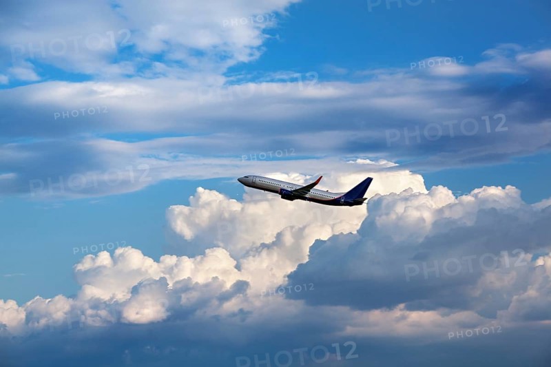 Modern passenger airliner flying in the cloudy sky