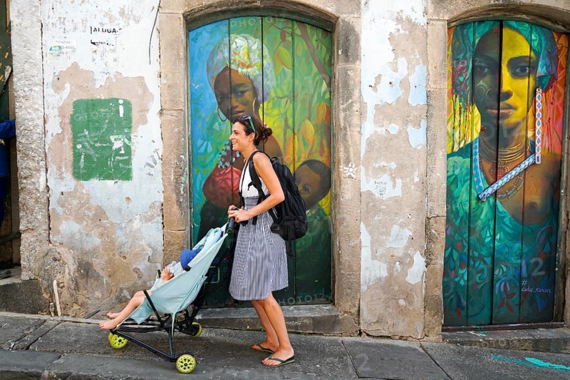 Tourist walking in the colorful historic district of Pelourinho, Bahia, Brazil. Historic neighborhood famous attraction for tourist sightseeing. February 11th, 2020
