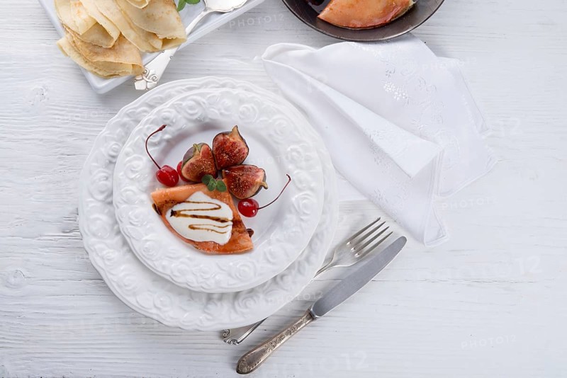 Flambe pancakes with figs and cherries