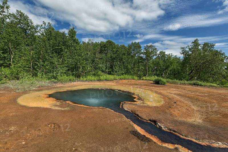 Beautiful summer landscape Kamchatka: views of the Hot spring Griffin by Ivanov, in Nalychevo Nature Park and travertine creek flowing from it. Kamchatka Peninsula, Far East, Russia, Eurasia