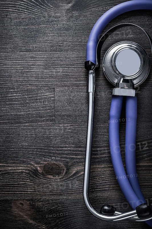 Medical stethoscope on wooden background top view medicine concept