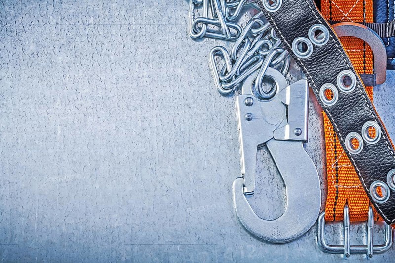 Safety belt metal chain carabiner hook on metallic background copy space