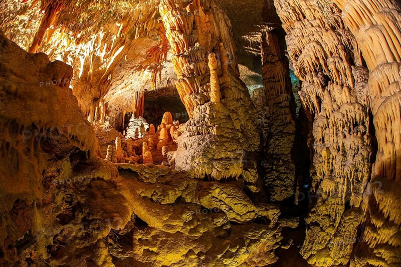 Postojna Cave. Colossal system of underground caves in Slovenia. Limestone plateau in Slovenia. Fantastically lit underground palaces with stalactites and stalagmites
