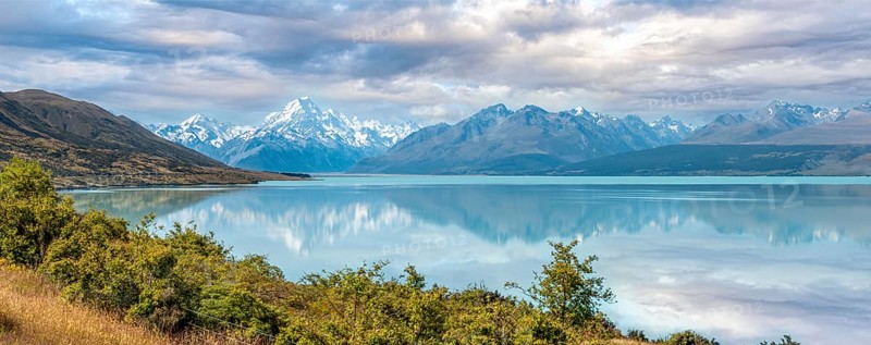 Scenic reflection of Mount Sefton and Mount Cook at lake Pukaki, South Island of New Zealand