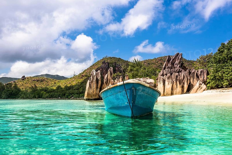 Old fishing boat on Tropical beach at Curieuse island Seychelles. Horizontal shot