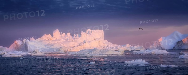 Floating glaciers in the rays of the setting sun at polar night