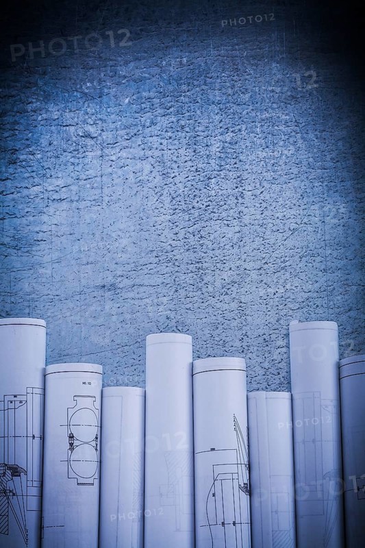 Scratched metallic surface with blueprint rolls construction concept