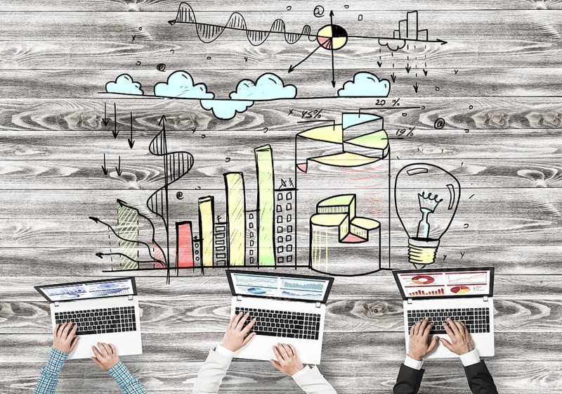 Group of people with devices in hands working together as symbol of networking and communication
