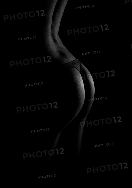 Rear view of sexual female body in black lingerie. Black and white photo