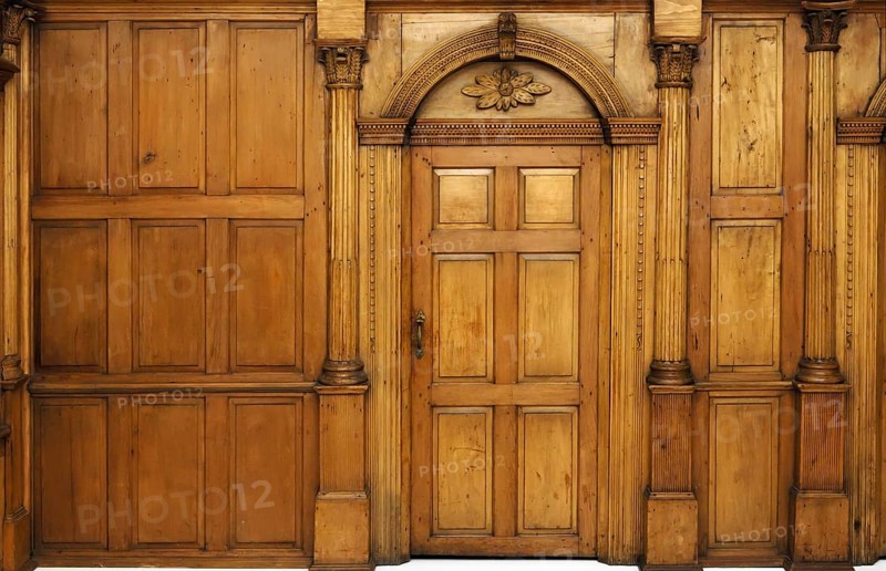 Wooden paneled wall and an arched door Victorian architecture style interior