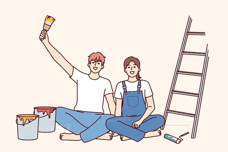Couple makes repairs in apartment with own hands and sits on floor near ladder and buckets of paint for painting walls. Cheerful man and woman rejoice at opportunity to make diy repairs in room