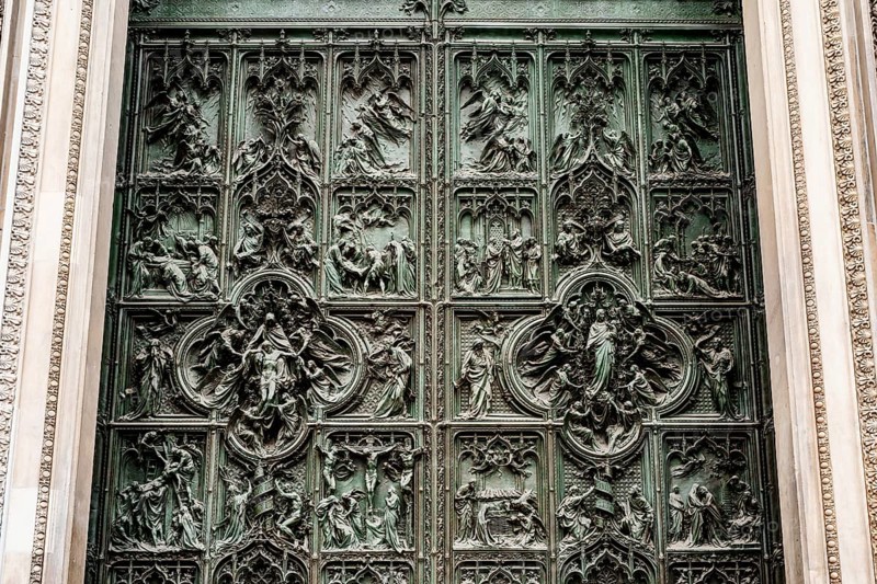 Entrance bronze door to the Duomo. Milan, Italy.