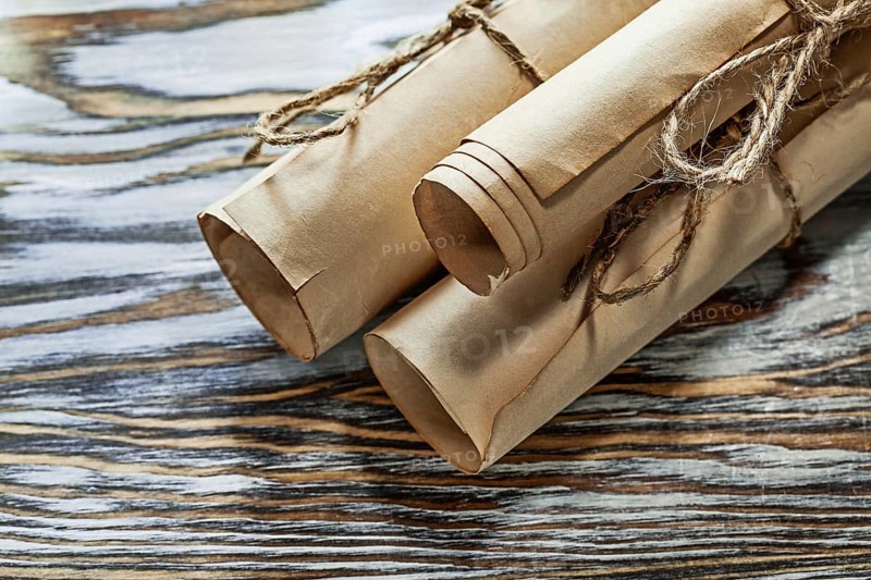 Medieval corded paper rolls on wooden board