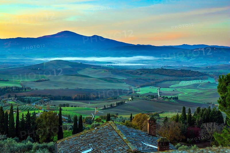 Predawn dusk. Tuscany. Photo taken on a protective wall around the ancient city of Pienza. The concept of active and photo tourism