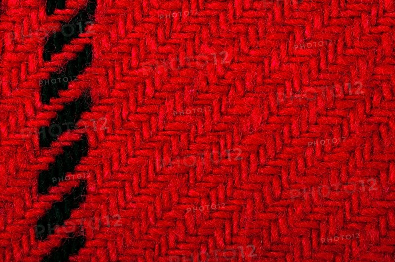 Handmade knit black and red background. Close up structure of the yarn. Christmas colors