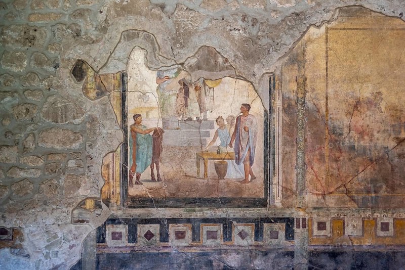 POMPEII, ITALY, MAY 04, 2022, Scenic painting of Roman inhabitants in a fresco of an ancient Roman villa in Pompeii, Southern Italy