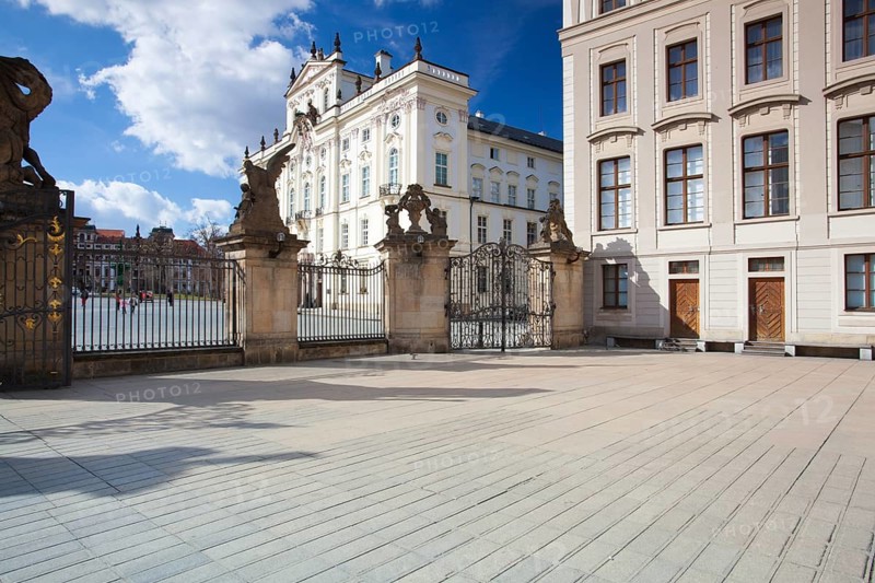 View on Archbishops Palace from the First Courtyard of Prague Castle. In the First Courtyard that visitors to Prague can witness the changing of the guards
