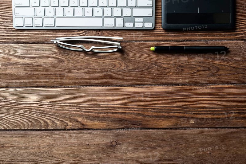 Top view office workspace composition. Flat lay vintage wooden desk with pc keyboard and graphic drawing tablet. Design and creativity. Time management and planning. Designer workplace organization