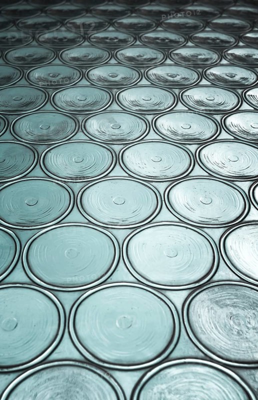 Green window with circular panes of swirled glass. Shallow depth of field