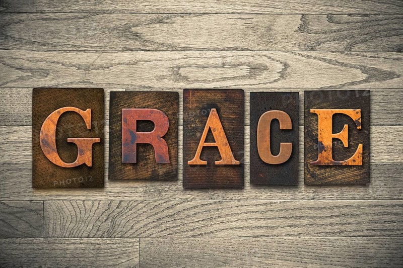The word GRACE written in wooden letterpress type