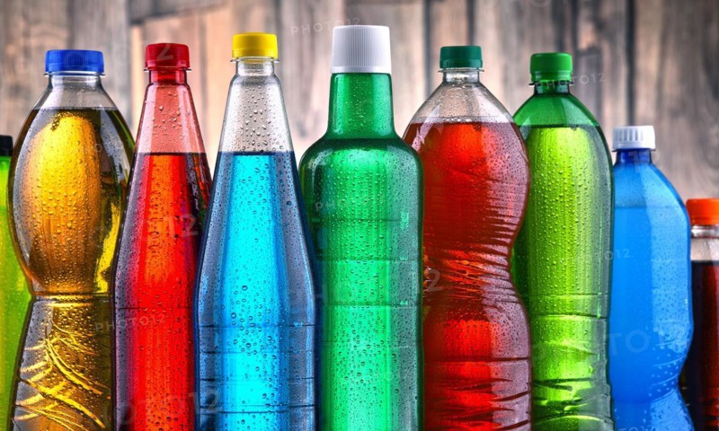 Plastic bottles of assorted carbonated soft drinks in variety of colors
