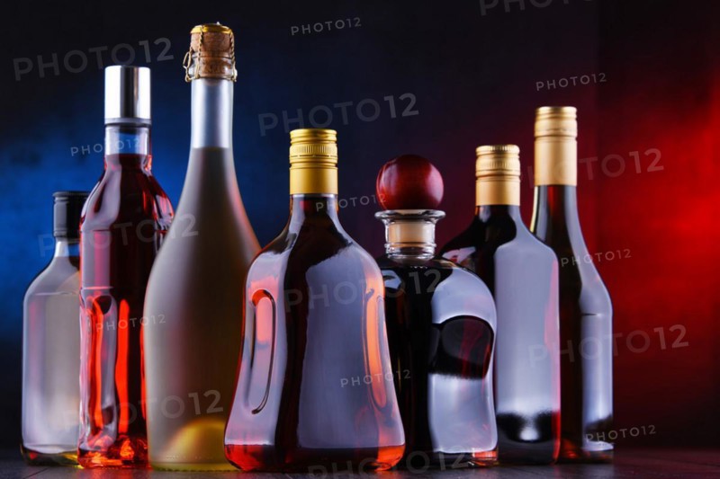 Composition with bottles of assorted alcoholic beverages