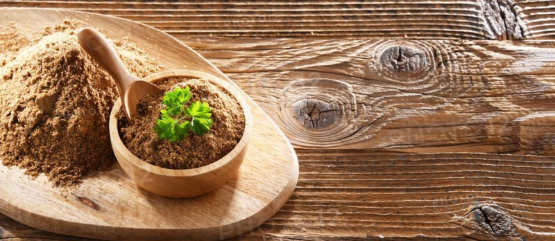 Composition with a bowl of ground coriander