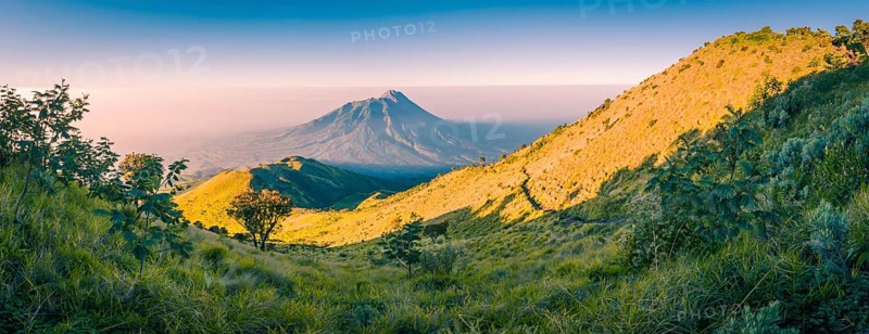 Panoramic photo of mountains surrounding Mount Merbabu near Yogya in central Java province in Indonesia. In this region, one can only meet people from isolated local tribes