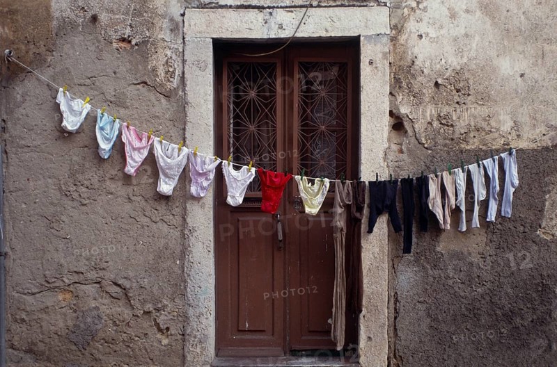 Clothesline in front of front door in Alfama, the old town of Lisbon, Portugal