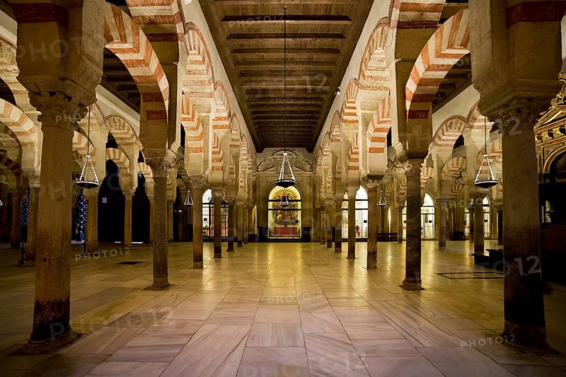 Hypostyle Prayer Hall in the Mezquita (The Great Mosque) with columns of jasper, onyx, marble, and granite supporting double arches in Cordoba, Spain