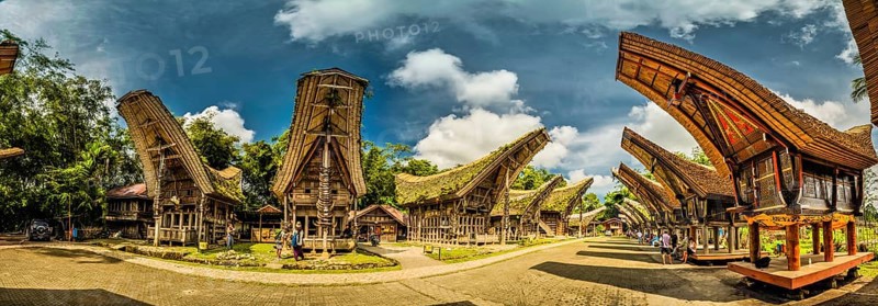 Sulawesi, Indonesia, May 2015: Panoramic photo of tongkonans with saddleback roofs and small square in Kete Kesu, Toraja region in Sulawesi, Indonesia. Documentary editorial