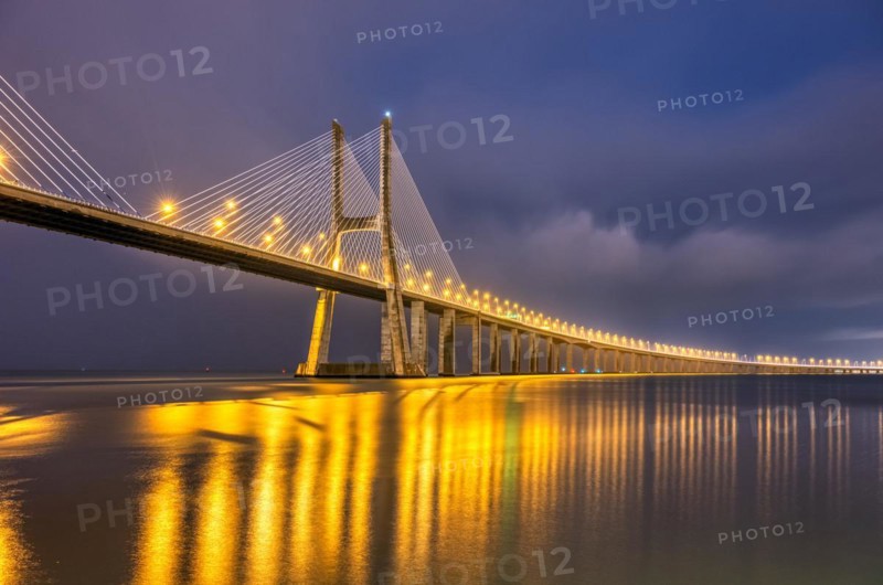 The famous Vasco da Gama cable-stayed bridge over the River Tagus in Lisbon, Portugal, by night