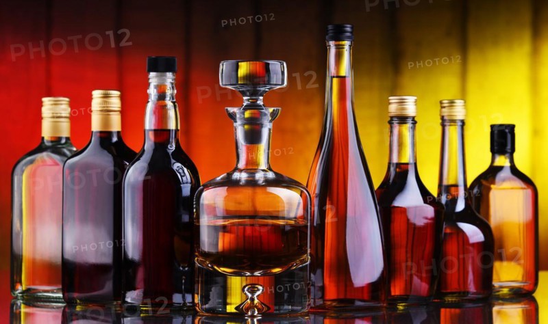 Composition with bottles of assorted alcoholic beverages