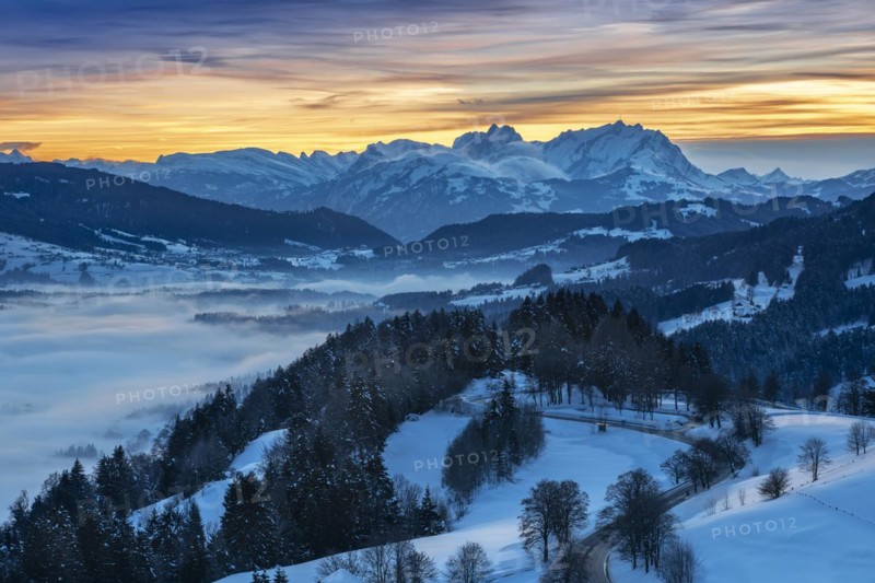 Dreamlike winter landscape at sunset with a view from the Allgäu Alps over the Bregenzerwald in Austria to the Säntis in Switzerland