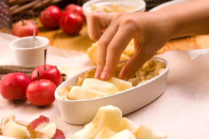 Detail of child hands making apple pie, lodz, poland