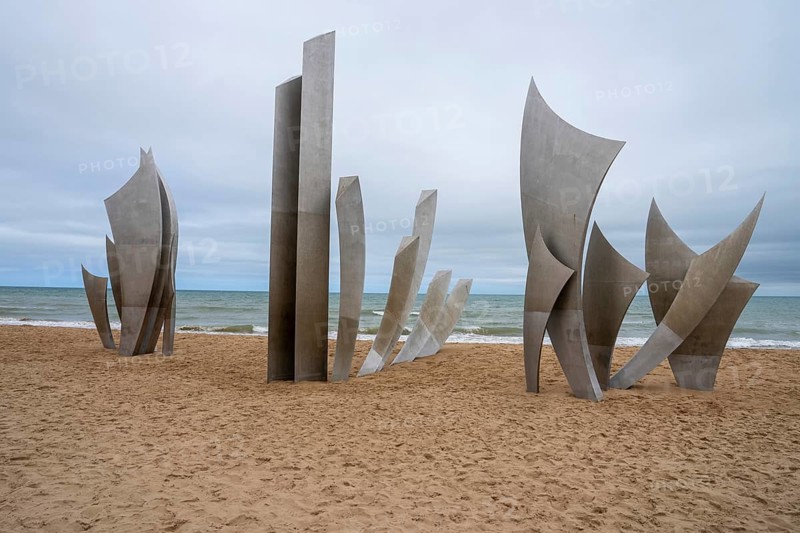 Les Braves, a striking monument on Omaha Beach, honors D-Day's heroes with three elements: Hope, Freedom, and Fraternity. It symbolizes the enduring spirit of unity, courage, and brotherhood from June 6, 1944