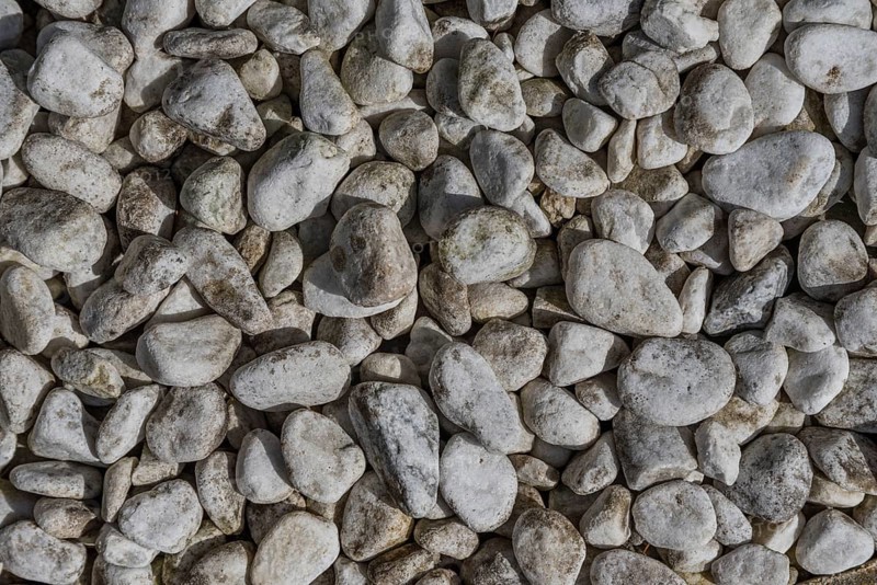 Gravel quarry - round rock and river gravel as background, bird's eye view