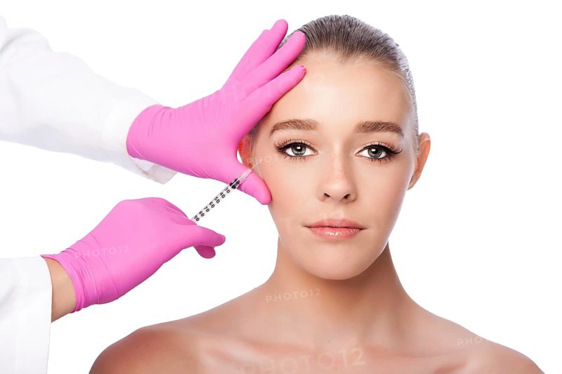 Beautiful face crows feet injection Cosmetic skincare spa beauty treatment with pink gloves by eye, on white, Atlanta, USA
